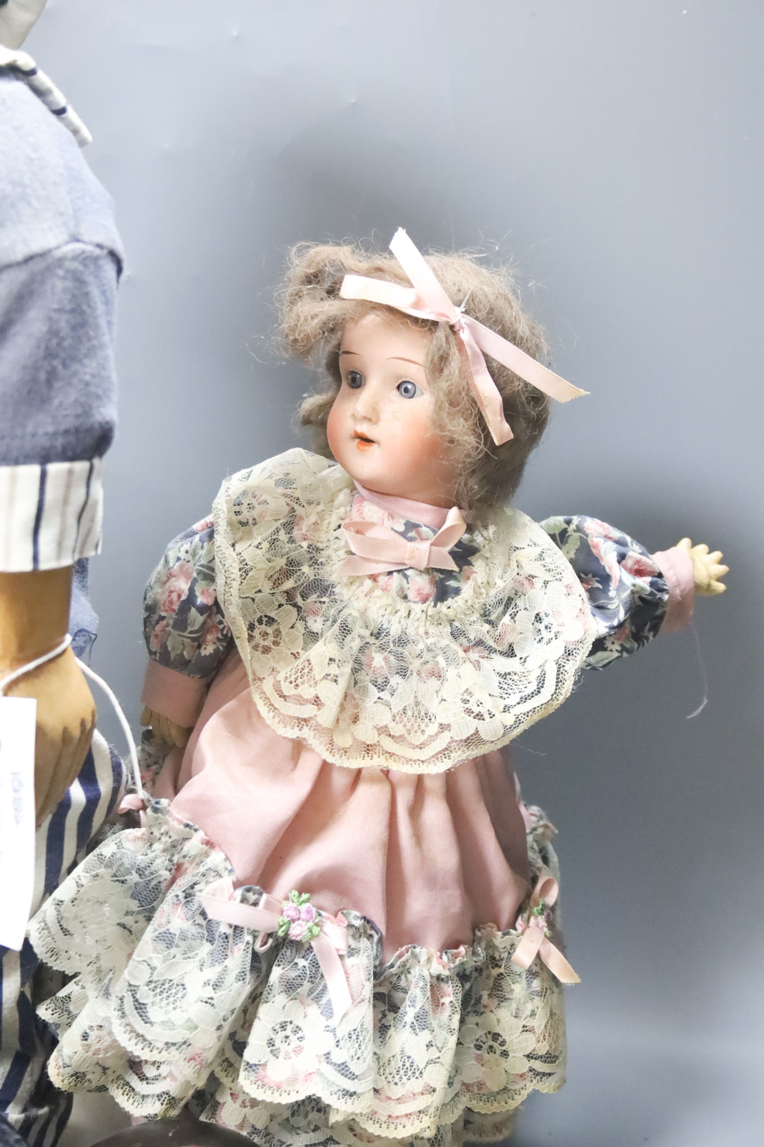 A black AM 351 cracked neck Schoneau & Hoffmeister jointed doll H13in. Black cream baby with wig crack to head H14in. two black dolls, one wood large sailor doll 20in.